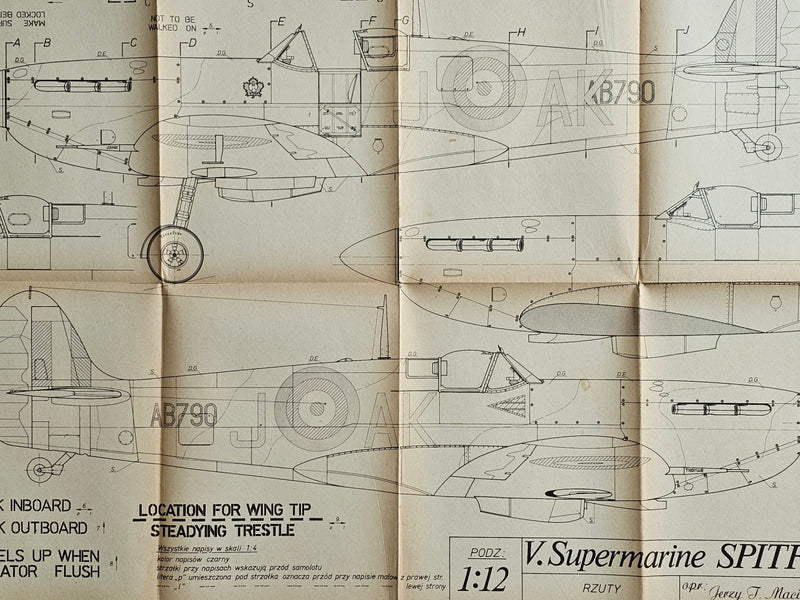 Photo of historic Spitfire Mk. I-V model plans by LOK, showing the detailed A1 sheets and the cover's wear, highlighting the collection's authenticity and age.