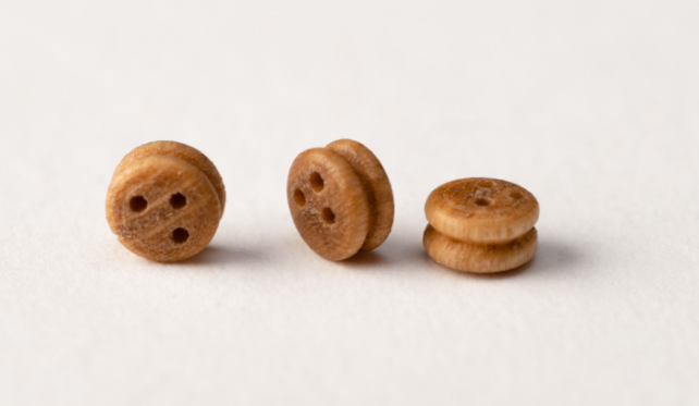 Image of Amati B4049,03 Walnut Deadeyes in 3mm, showcasing a set of finely crafted, rich-colored walnut miniature deadeyes, perfect for detailed rigging in model shipbuilding.