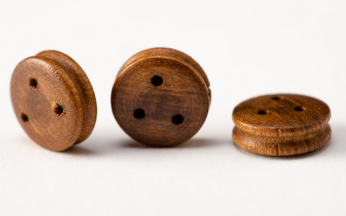 Image of Amati's 9mm Walnut Deadeyes, catalog number B4049,09, showing a set of finely crafted walnut deadeyes, essential for adding realistic rigging detail to historical model ships and maritime dioramas.